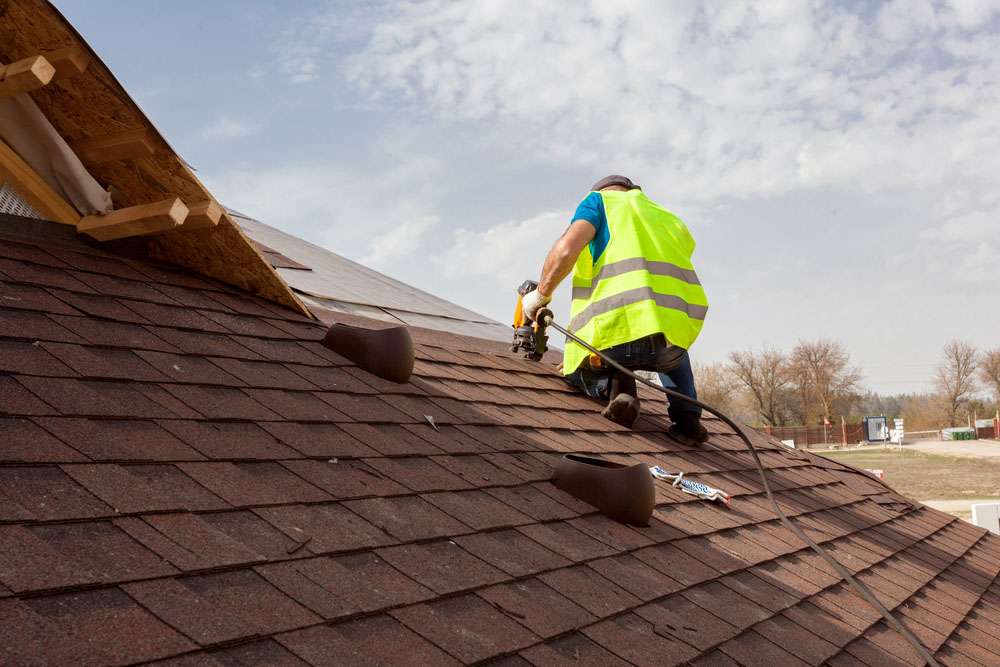 Roofing contractor working in rainy weather